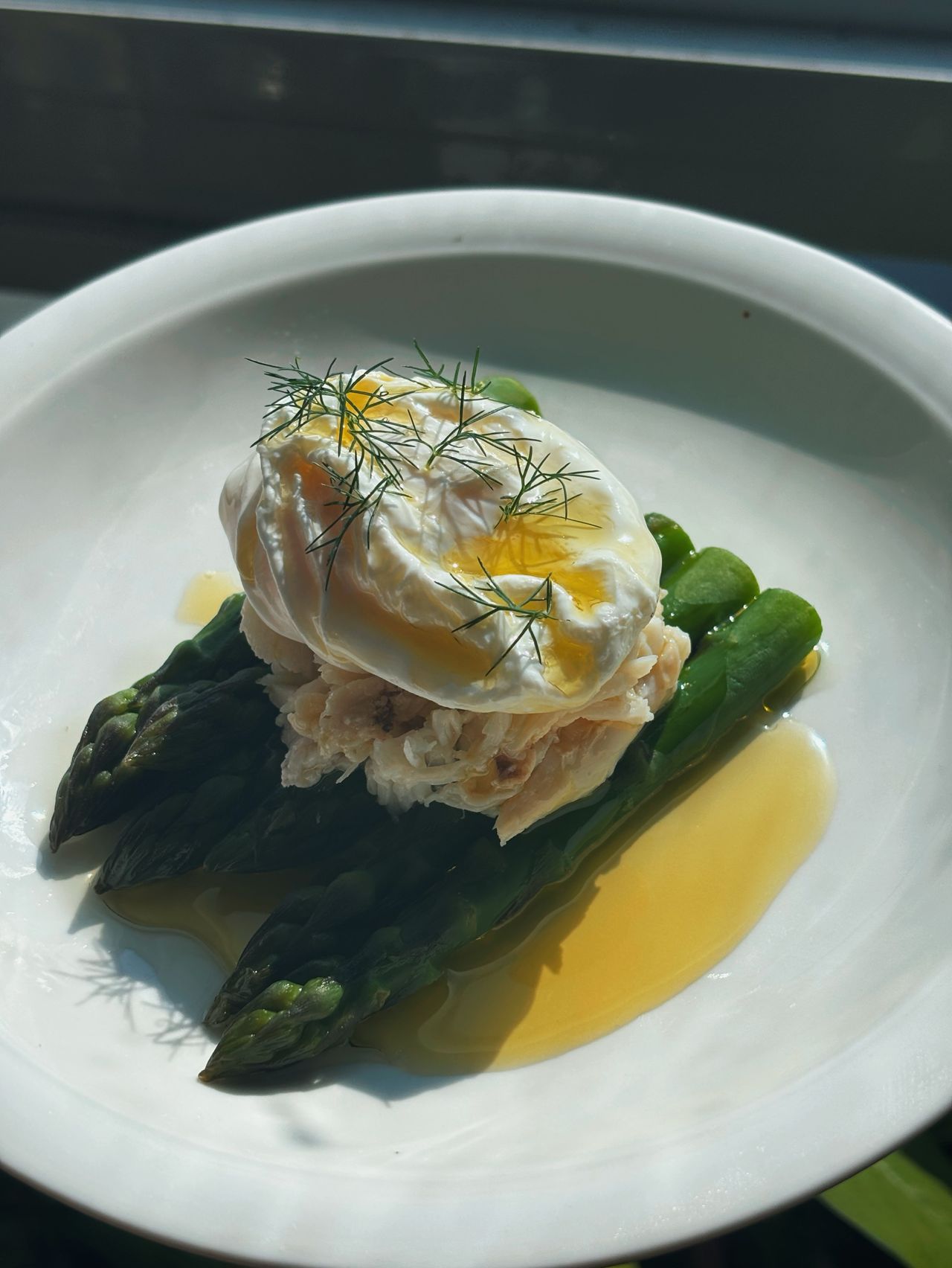 Asparagus topped with crab and a poached egg