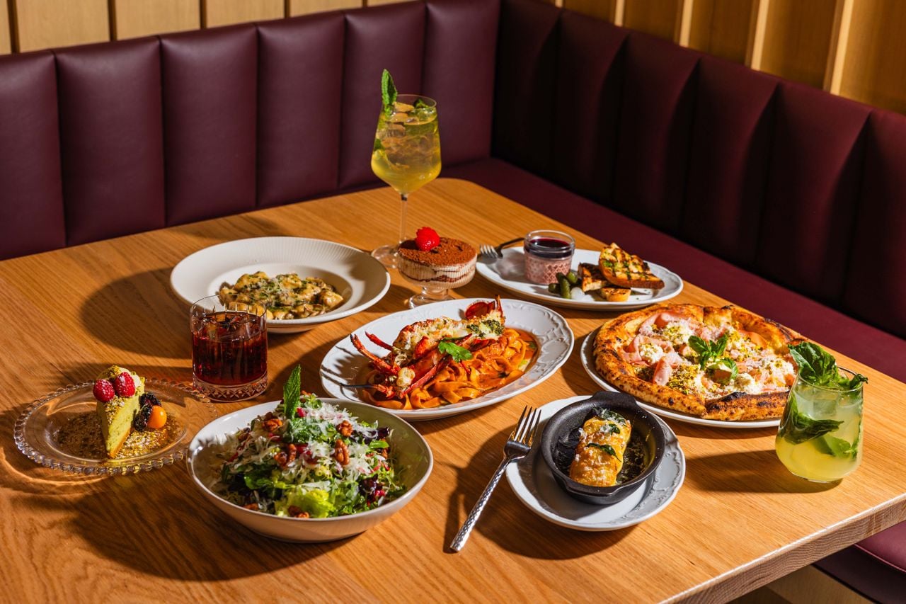 A spread of dishes and drinks at Osteria Alba