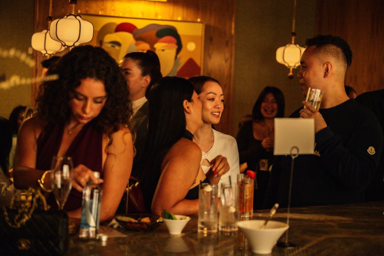 People chatting at a bar