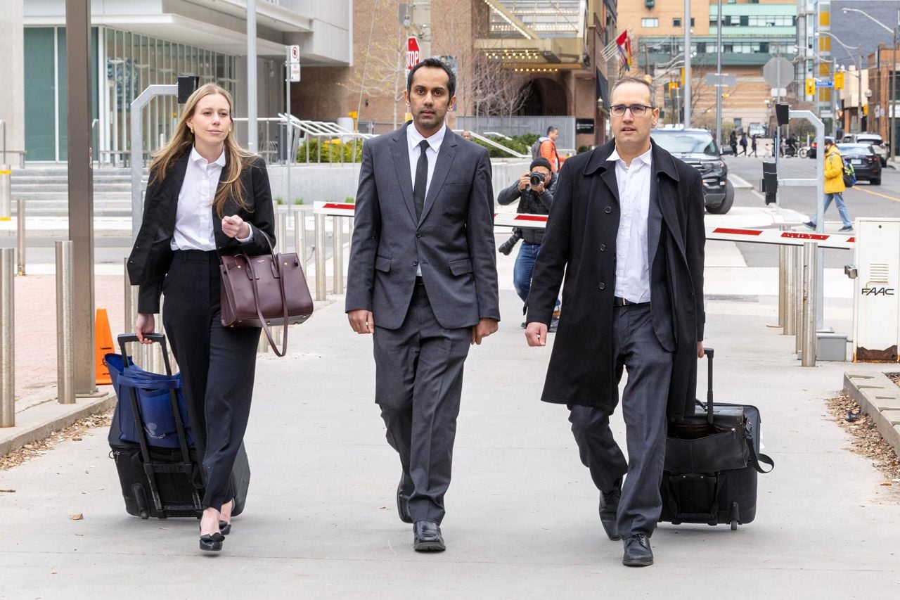 Umar Zameer walks with lawyers Nader Hasan, right, and Alexandra Heine.