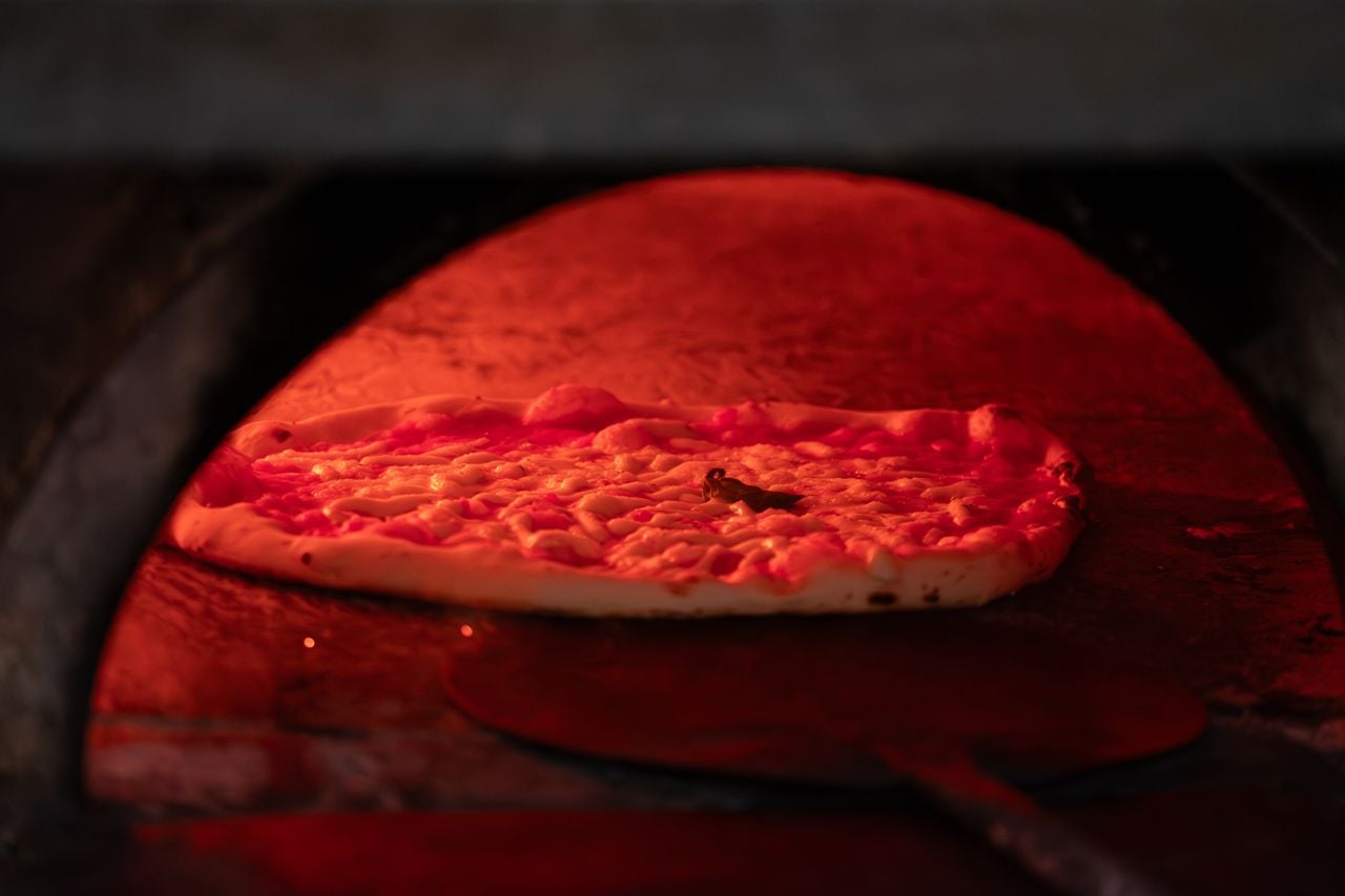 A pizza bakes in an oven.