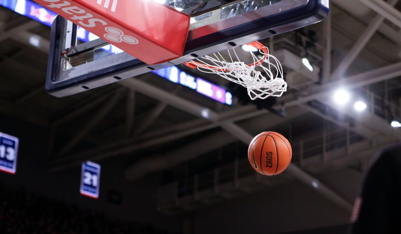 A basketball sails through the hoop.