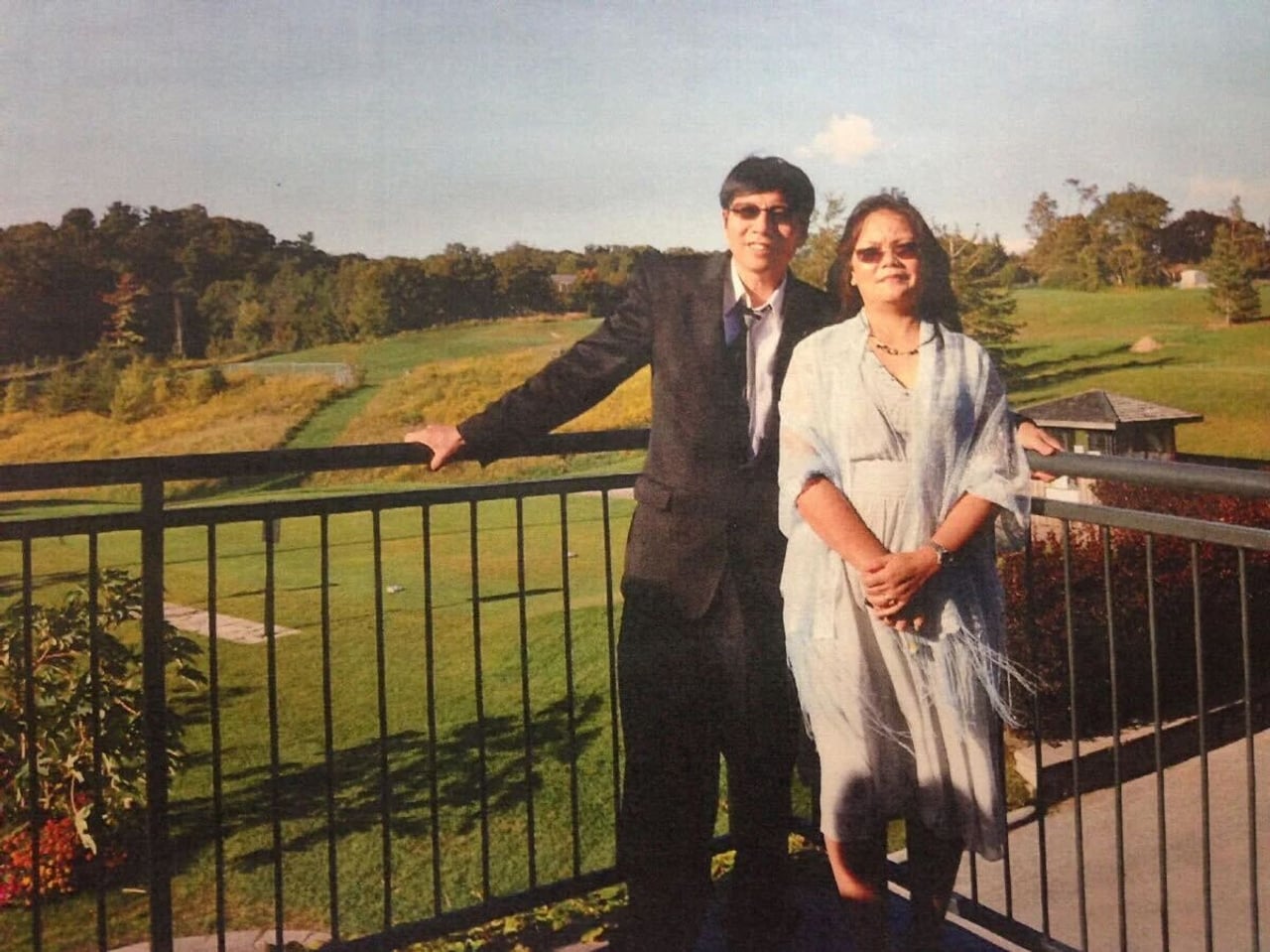 Bich Ha Pan and Hahn Pan pose together in front of a large lawn.