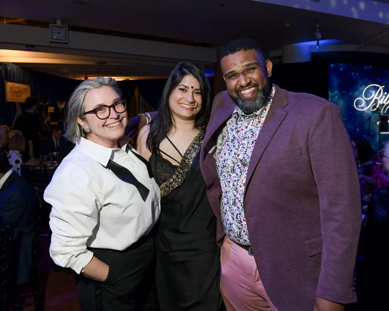 Three people posing together