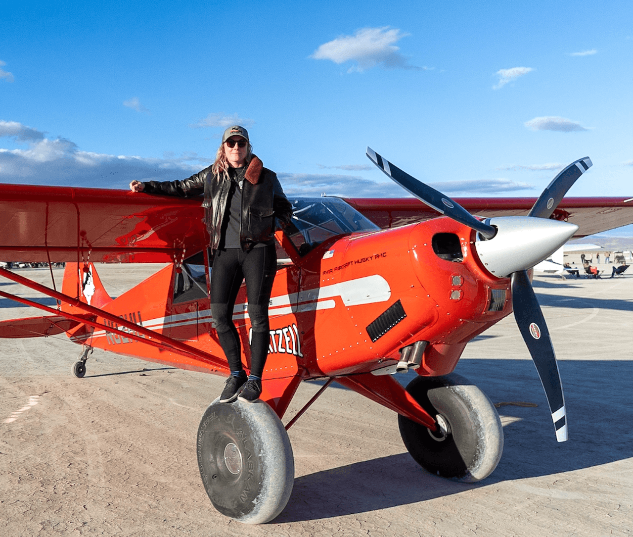 Woman standing on the wheel of an airplane