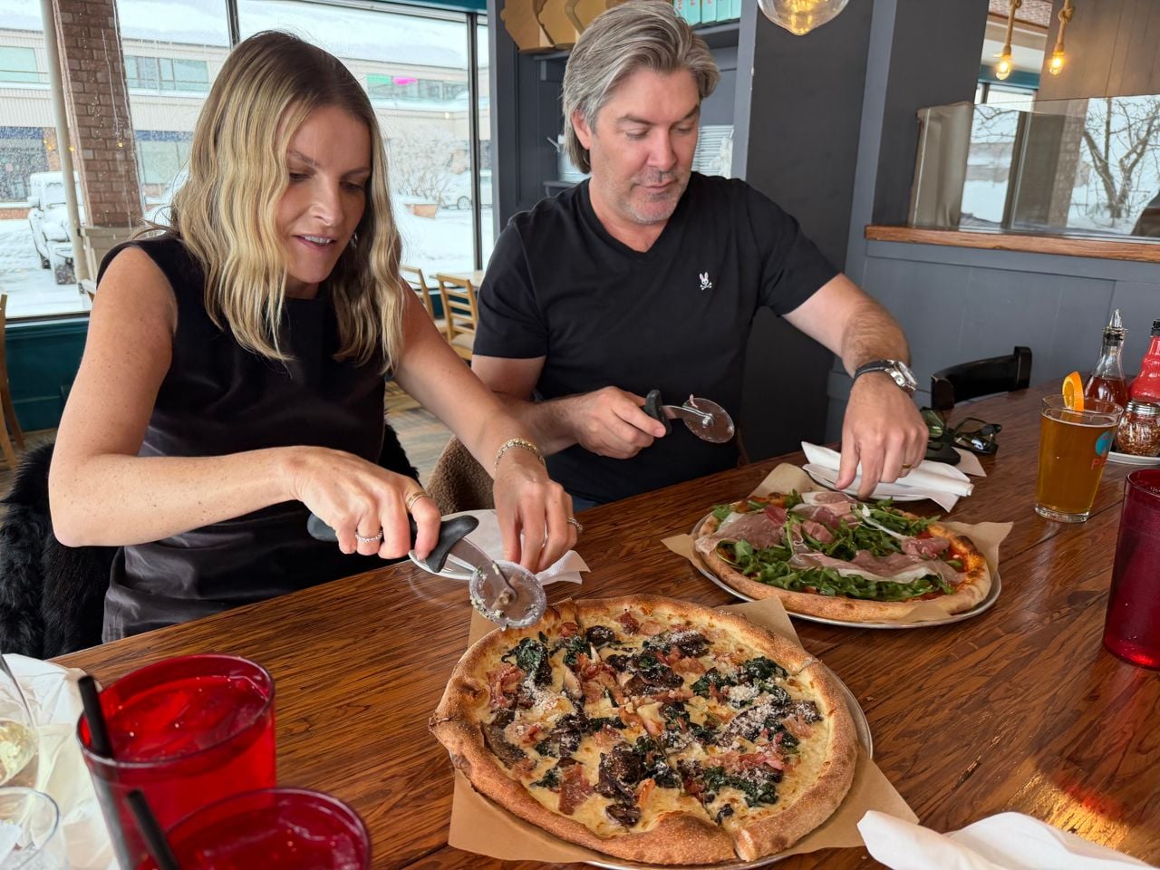 Katherine and Randy Feltis slice pizza