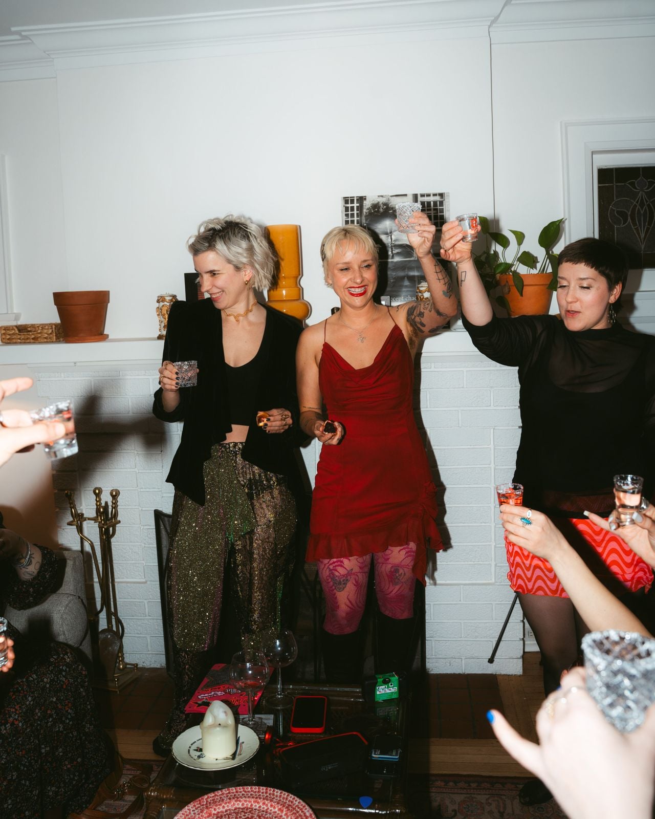 Three women raise glasses in cheers