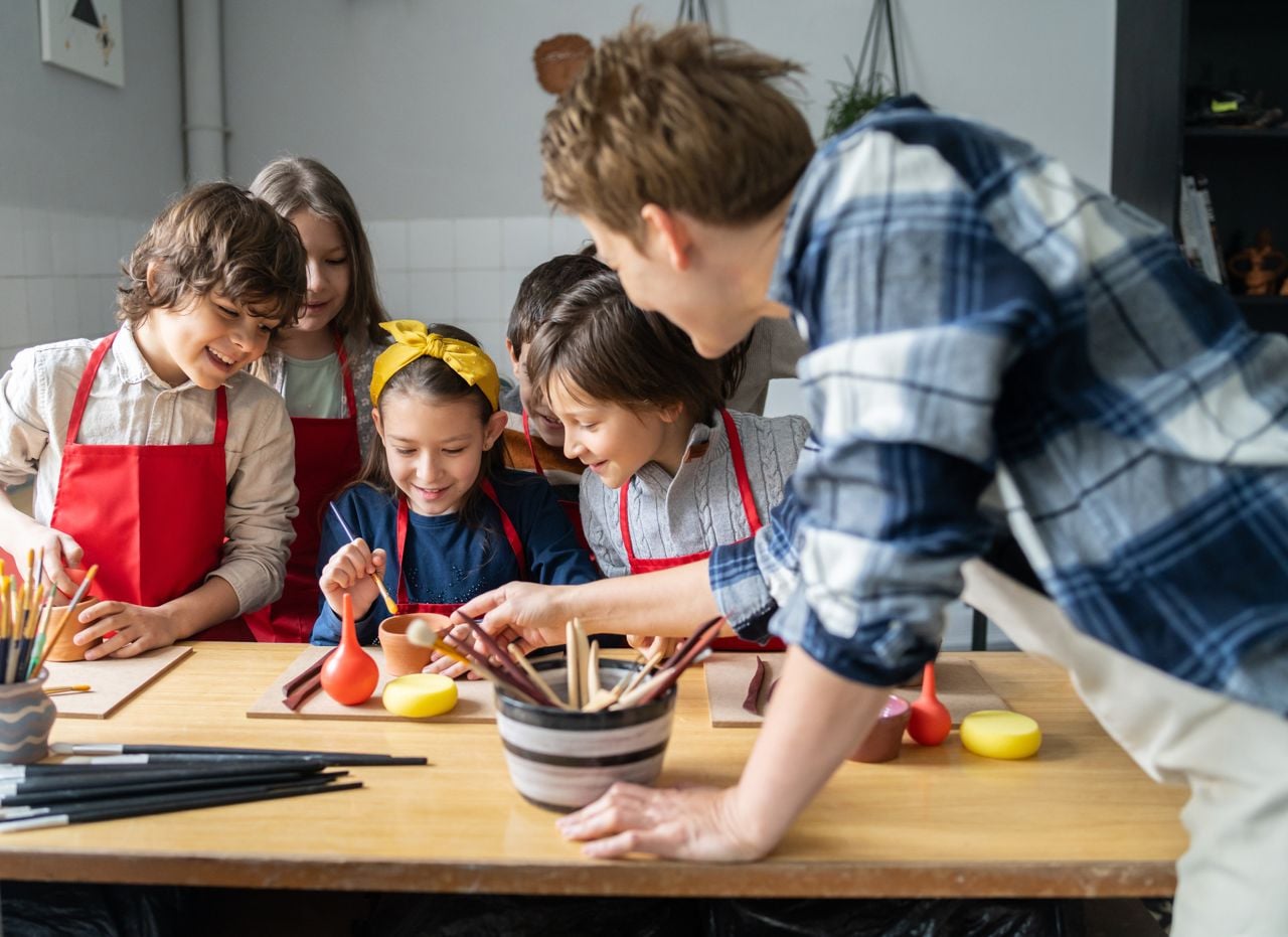 A group of kids doing arts and crafts with an instructor
