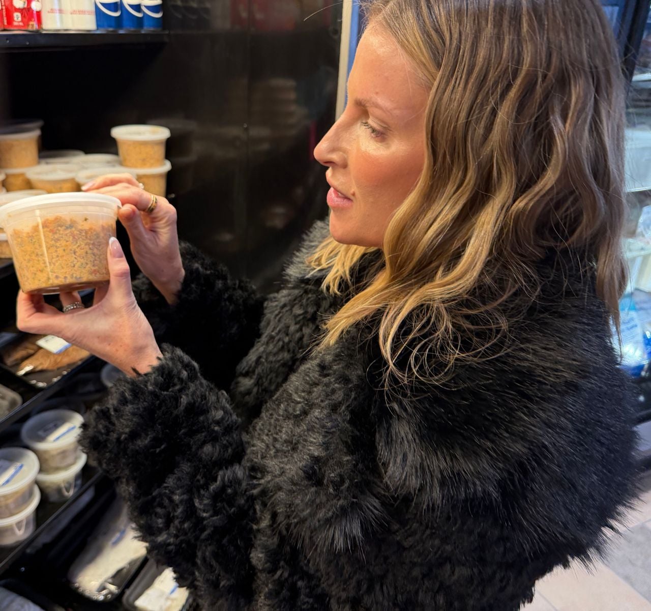 Katherine Feltis examines a container at Johnny's Seafood