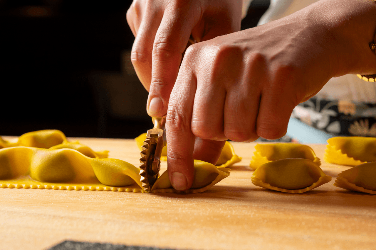A person cuts pasta