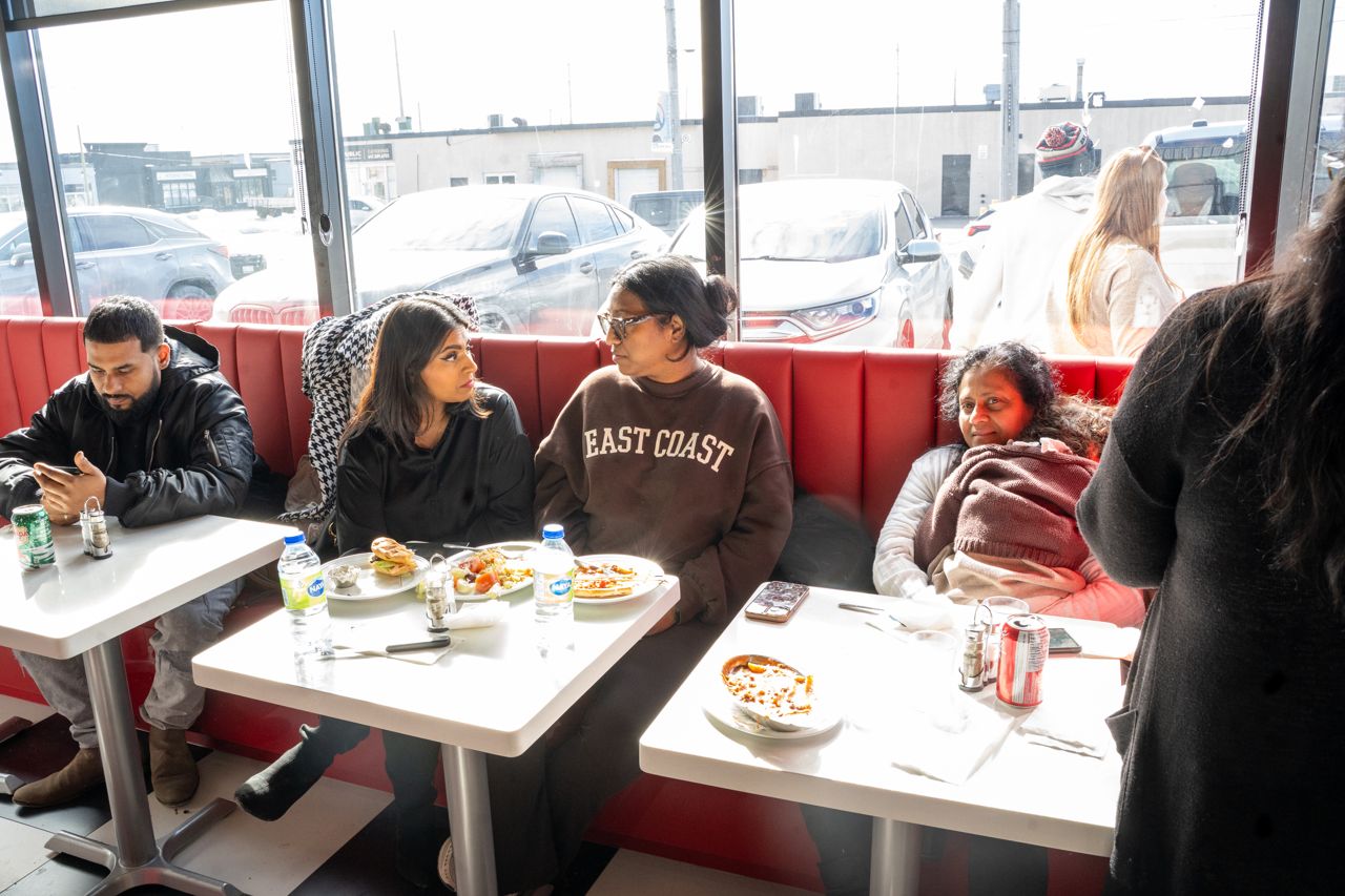 People sit at tables in the dining room of Spano's Diner