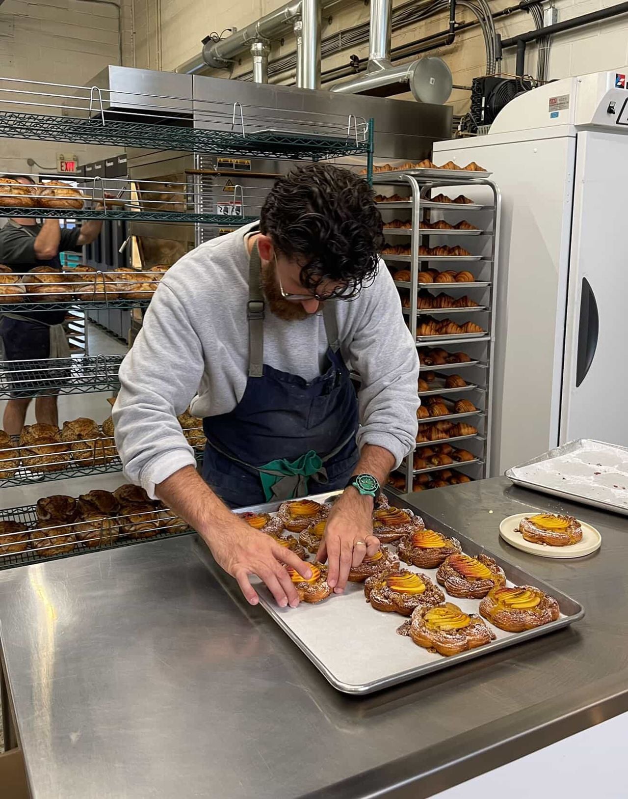 A pastry chef preps pastries at a bakery