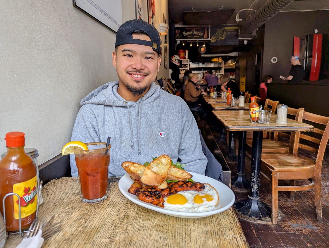 Chef Julian Cawagas at Easy Restaurant, with an order of eggs and a caesar