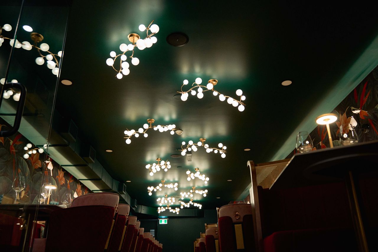 A closeup of the light fixtures on the ceiling of Aangan's dining room
