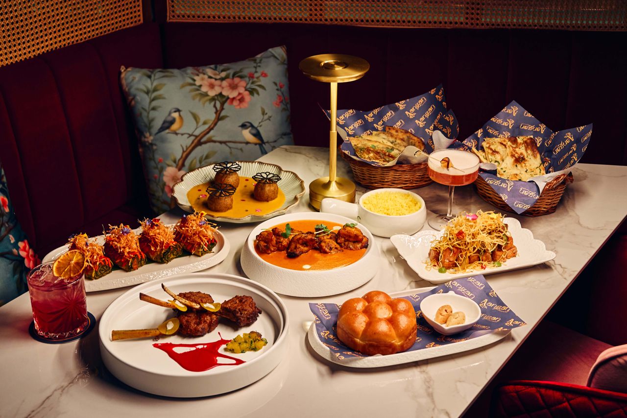 A spread of dishes and drinks at Aangan