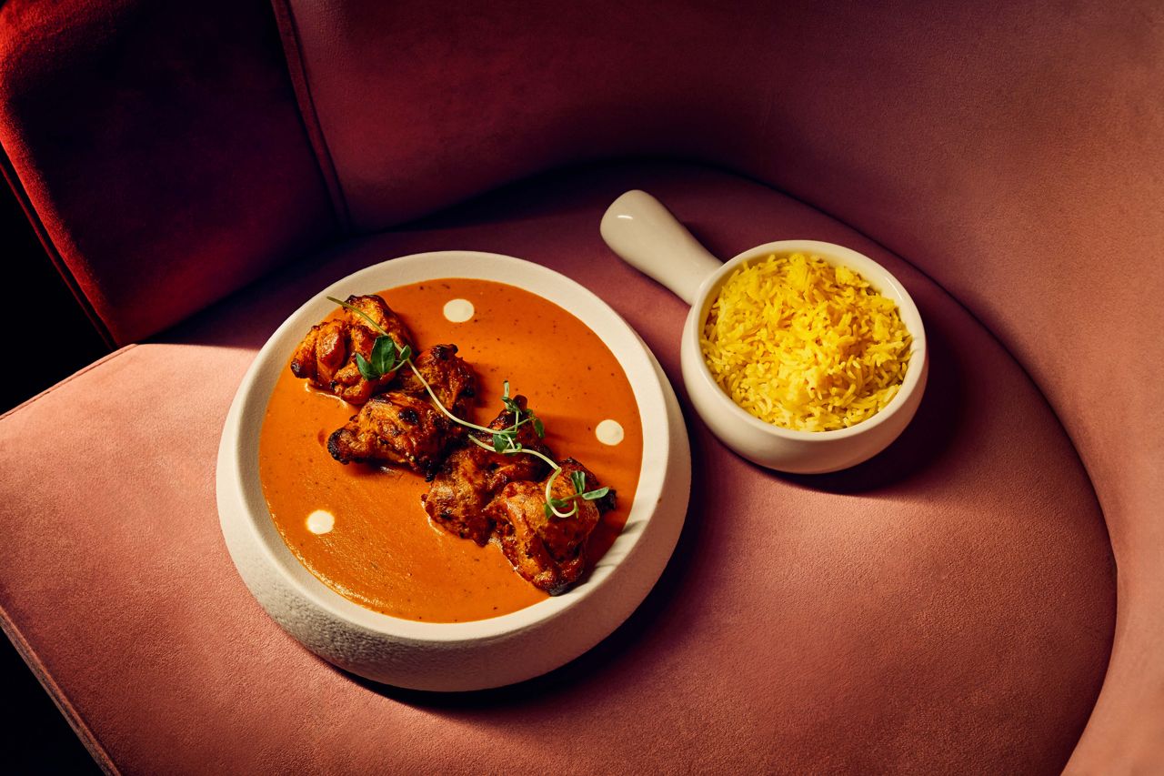 Deboned chicken thighs marinated in yogurt and tandoori spices and served over a silky sauce of tomato, cashews, fenugreek, curry leaves and tandoor-roasted peppers