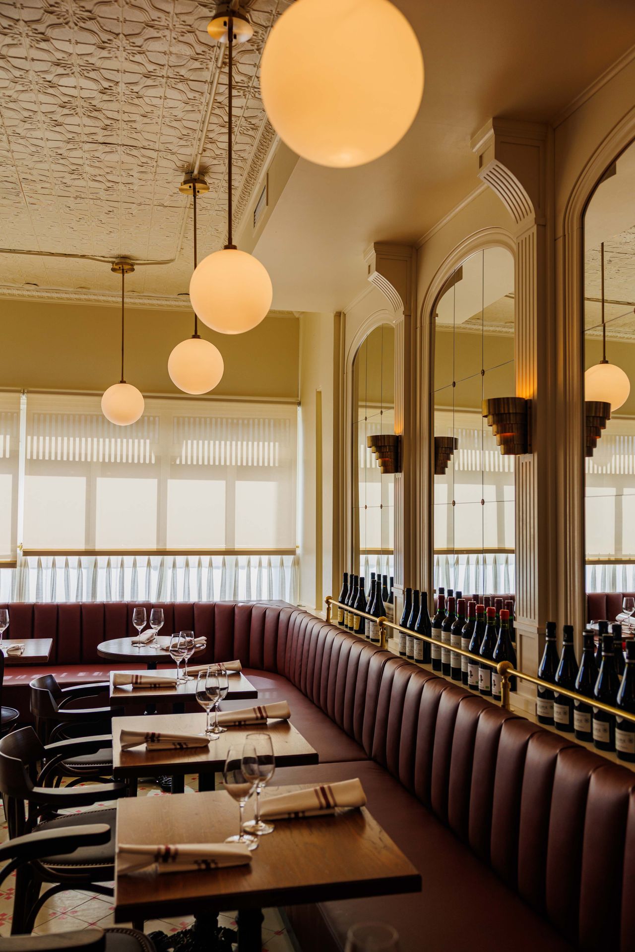 Red leather banquette seating in the dining room of Brasserie Côte