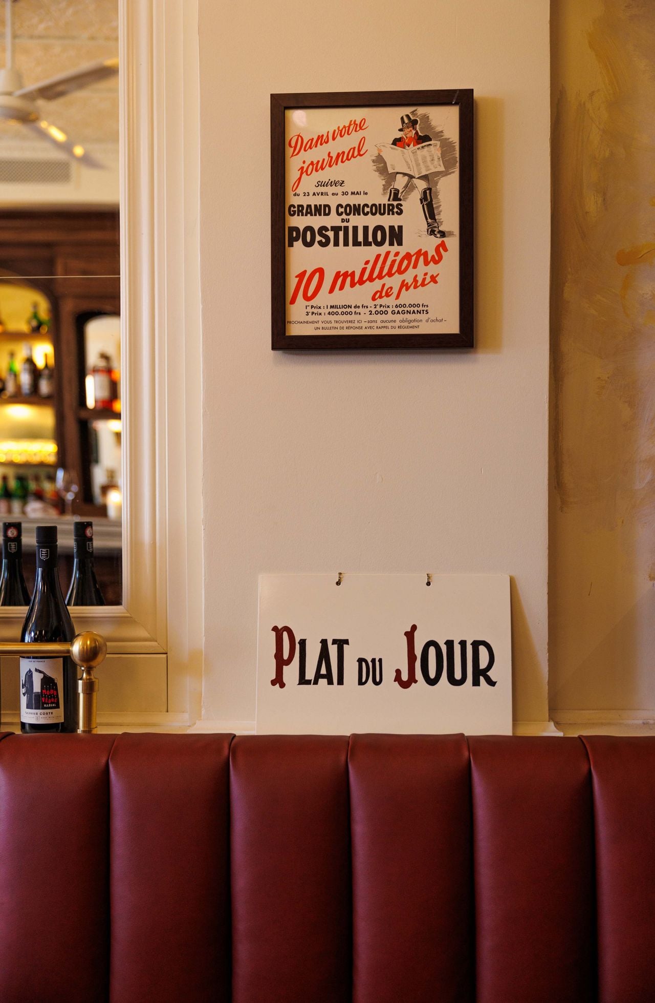 A framed French advertisement on the wall at Brasserie Côte
