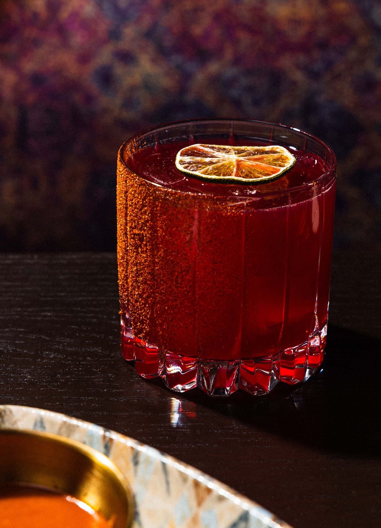 The Land of Fire starts with Cazadores tequila infused with hibiscus and orange zest, then meets lime and an ancho-honey syrup for a spicy, slow-burning take on the margarita