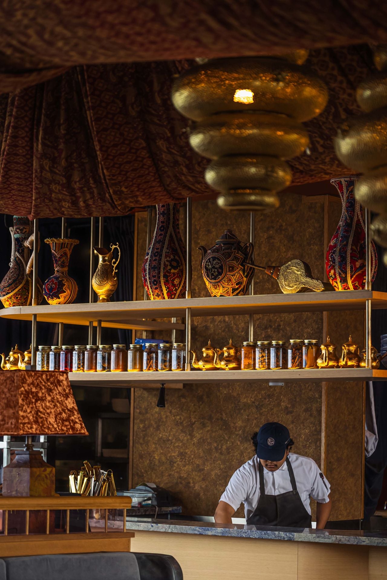 A chef works in the open kitchen at Mar'aa
