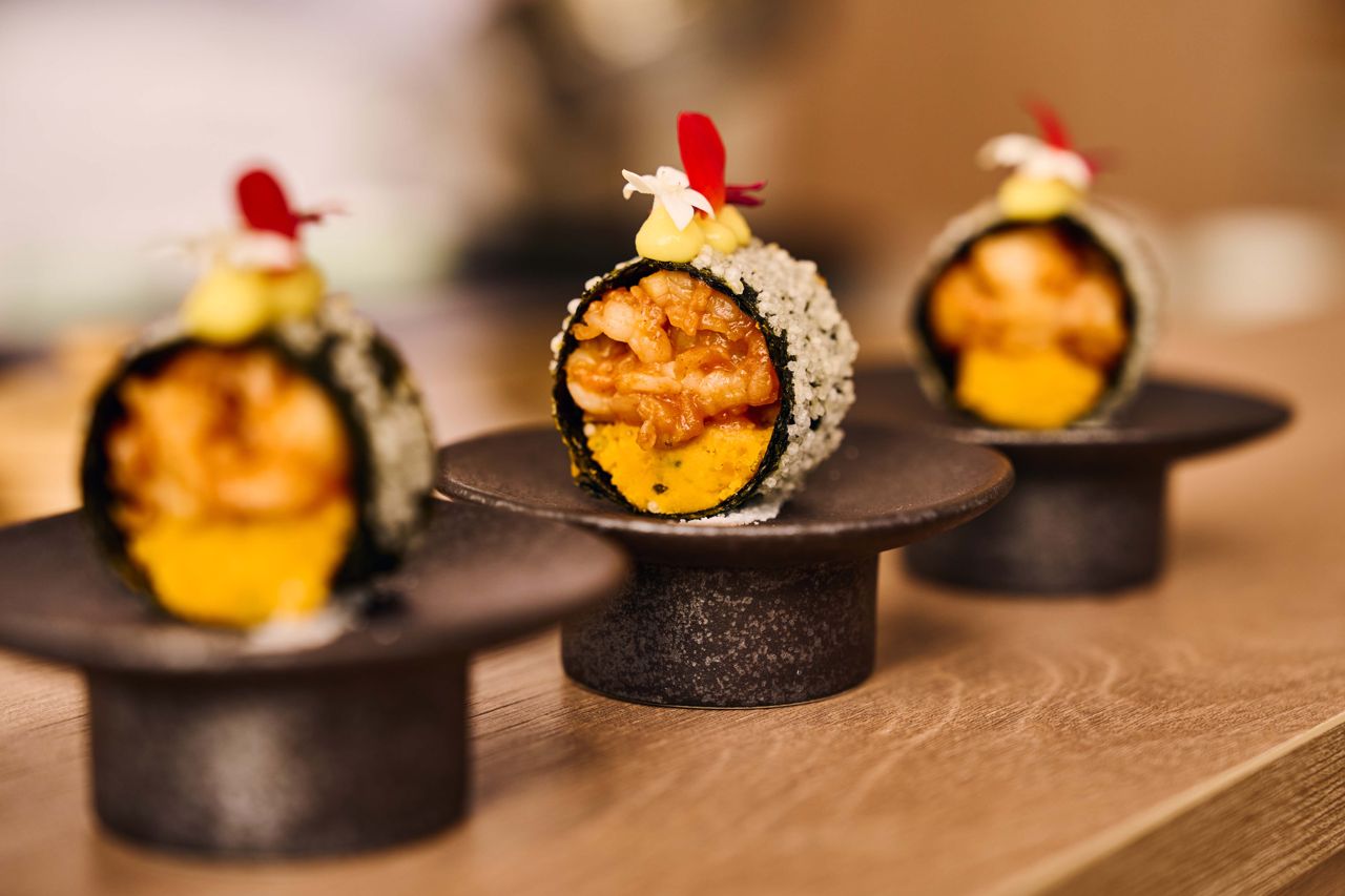 Butter-poached lobster, lacquered with gochujang and folded into crisp nori with sweet pumpkin