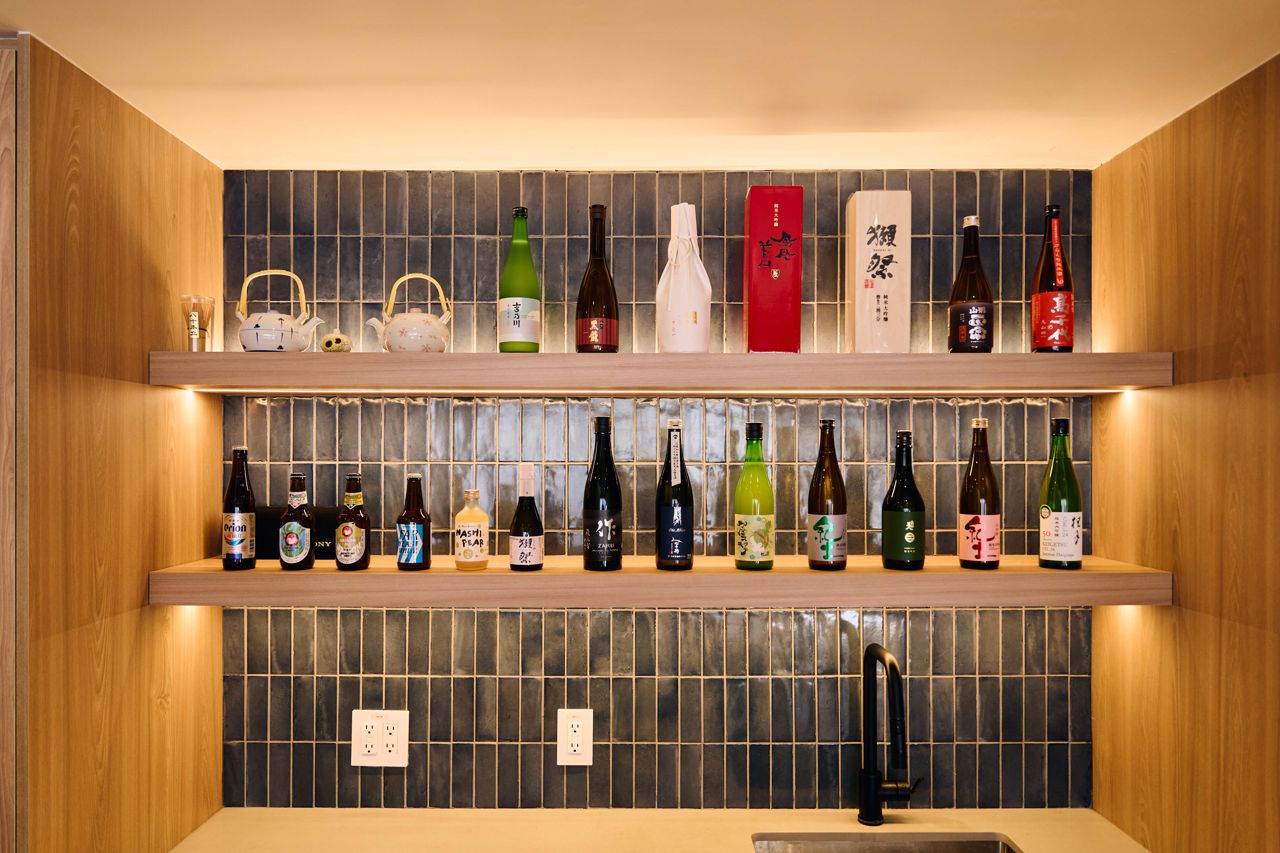 Shelves lined with bottles of sake and Japanese beer at the Onda