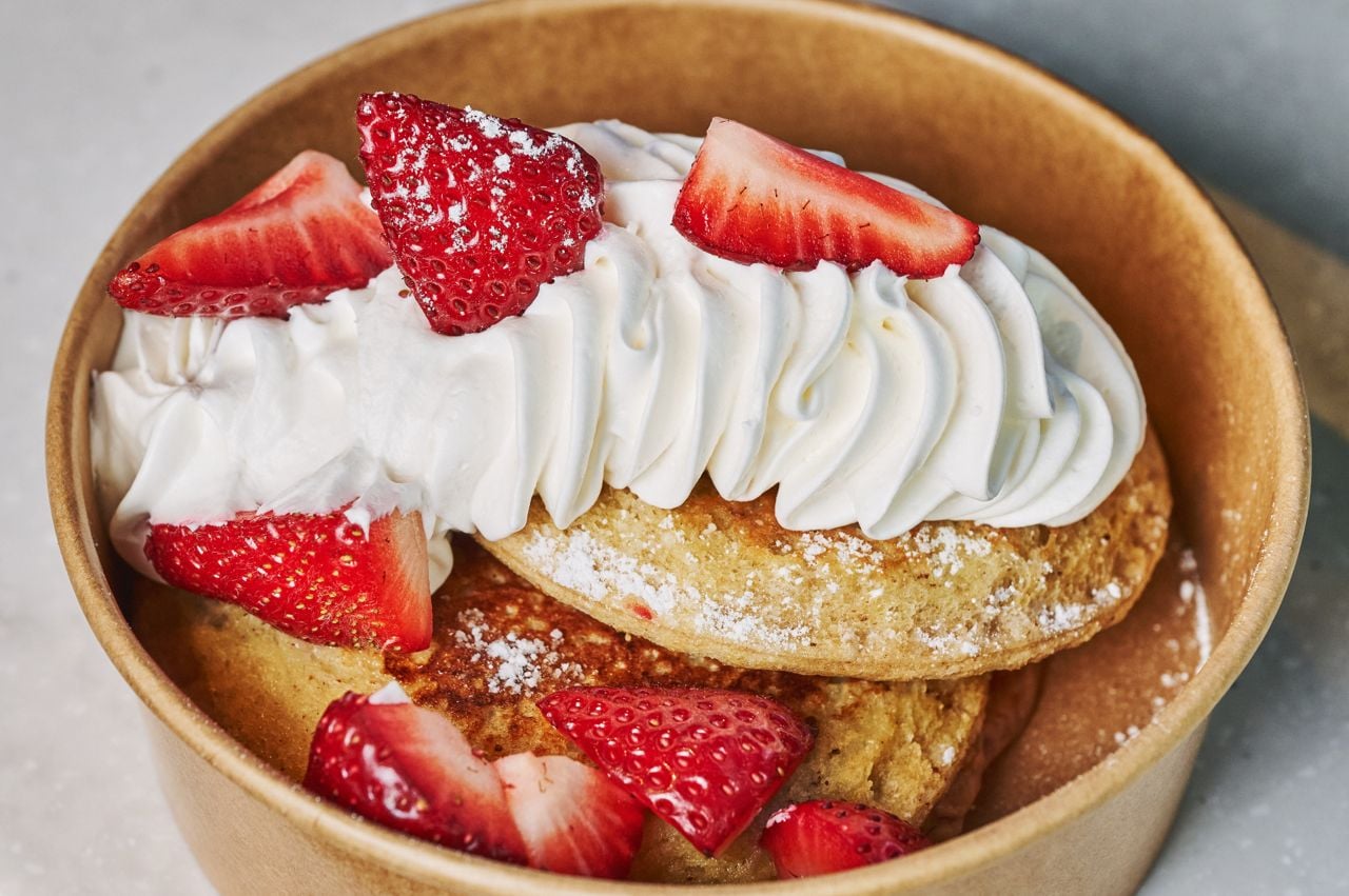 Uncrustables French toast topped with whipped cream and strawberries