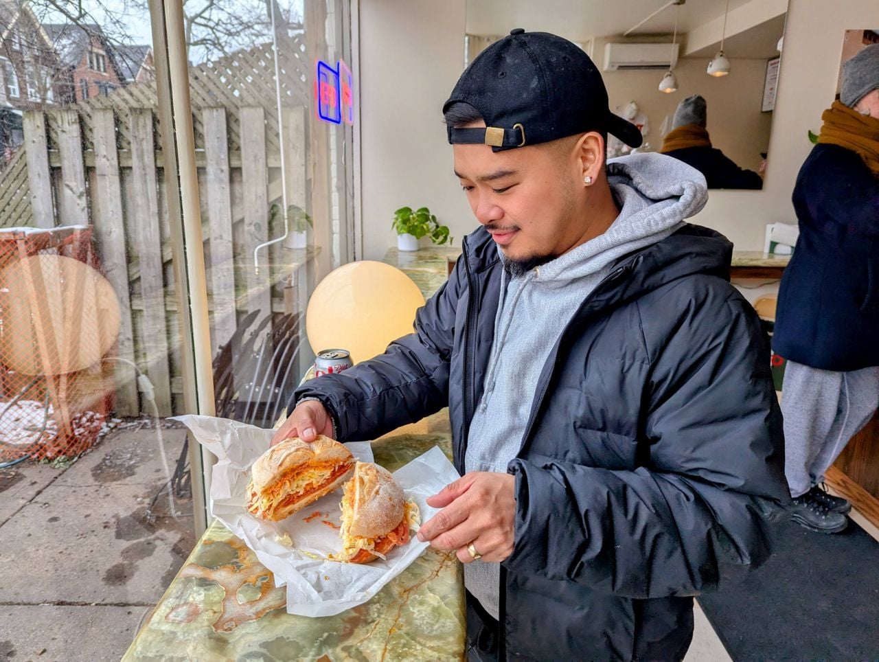 Chef Julian Cawagas with a sandwich at Tutto Panino
