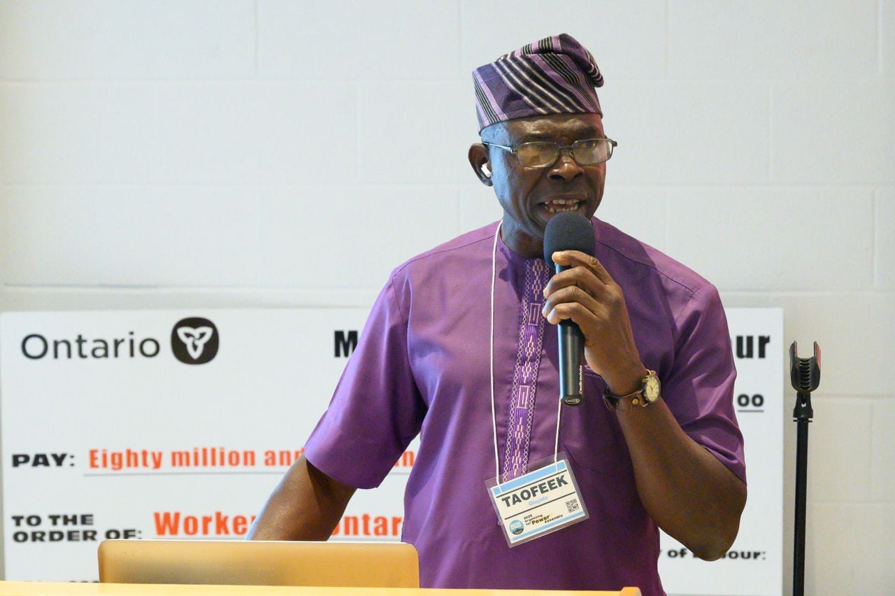 Taofeek Olajide speaking at a podium