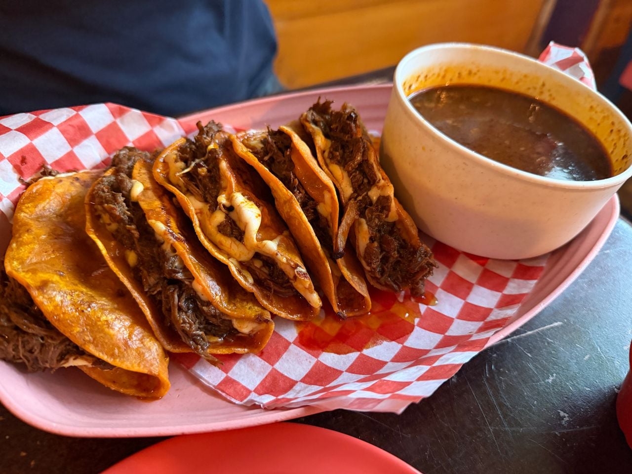 An order of birria tacos and consome