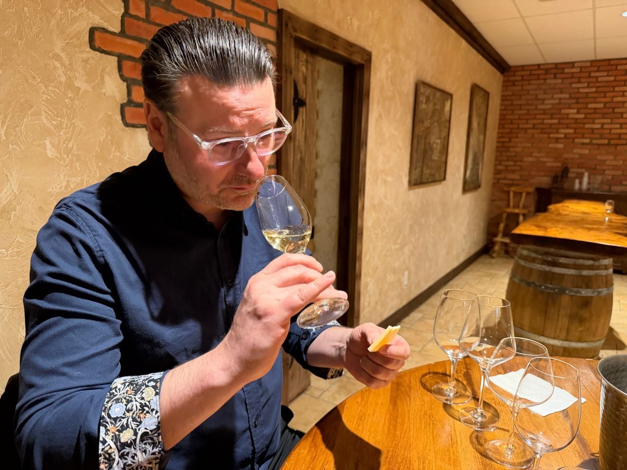 Riley Krieger-Mercer sniffs a glass of white wine