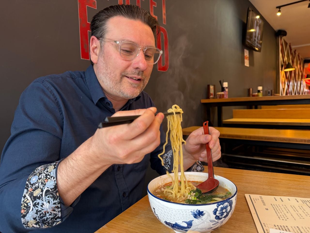 Riley Krieger-Mercer eats a bowl of ramen