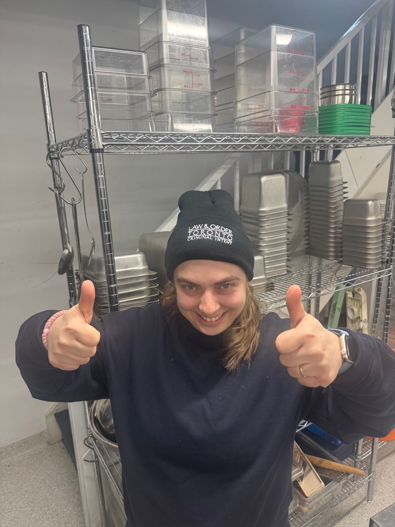 Chef Shauna Godfrey, wearing a Law and Order Toronto toque, gives two thumbs up