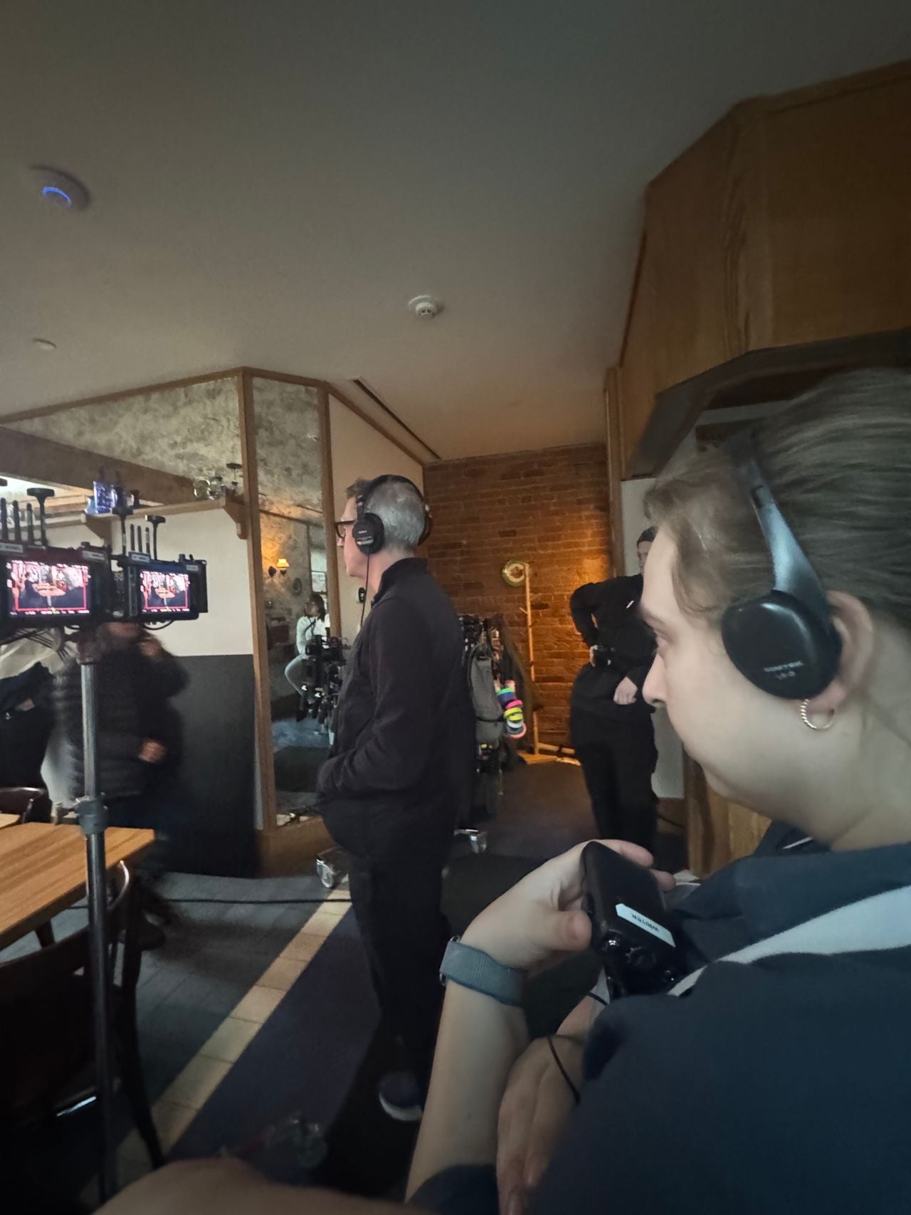 Shauna Godfrey and crew members watch as a scene is being filmed in her restaurant