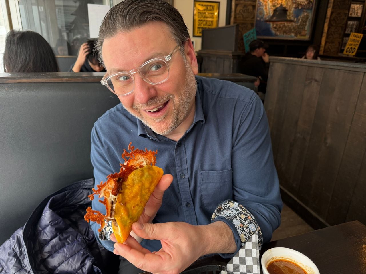 Riley Krieger-Mercer holds a birria taco