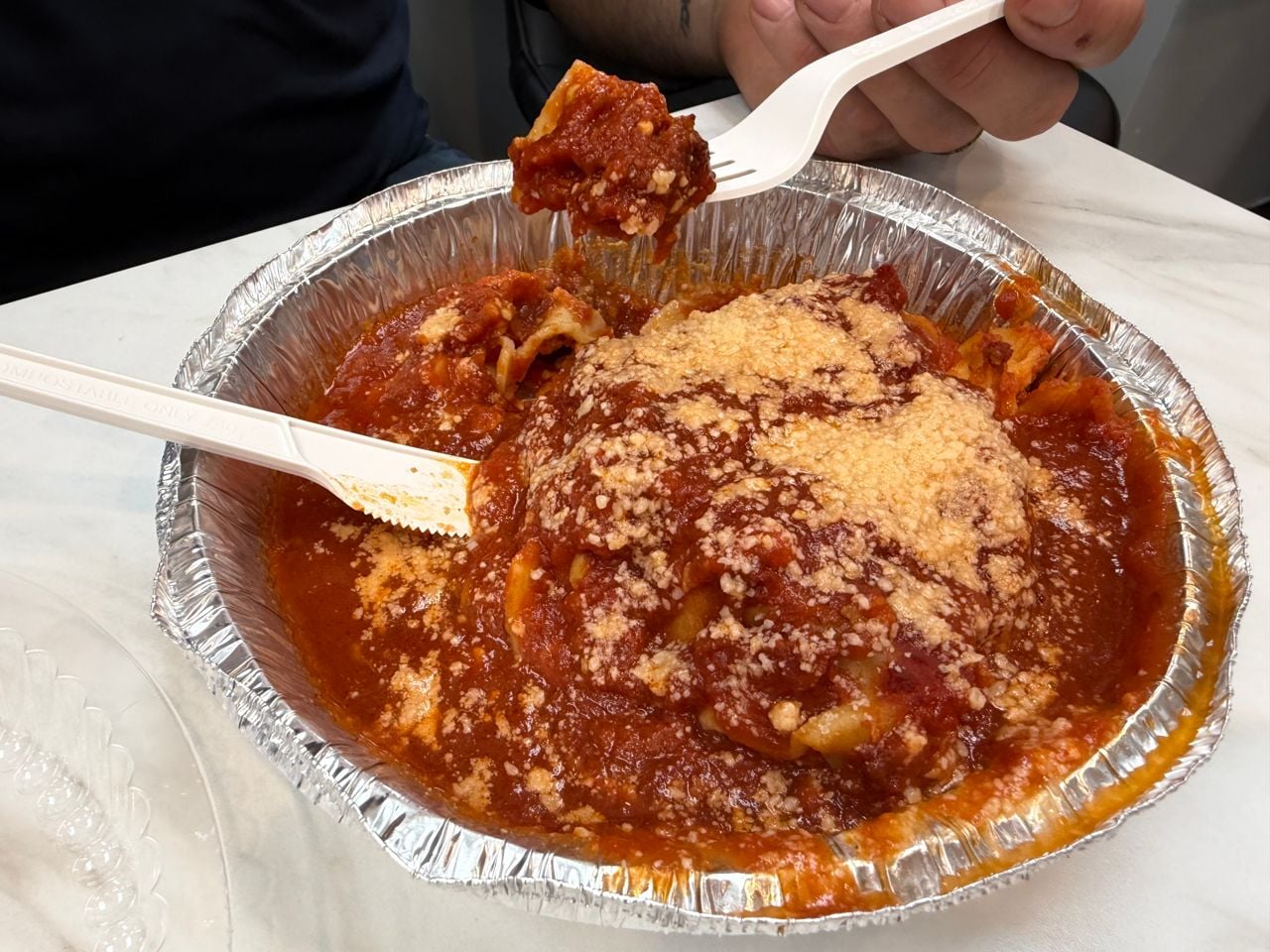 A closeup of lasagna in an aluminum tray