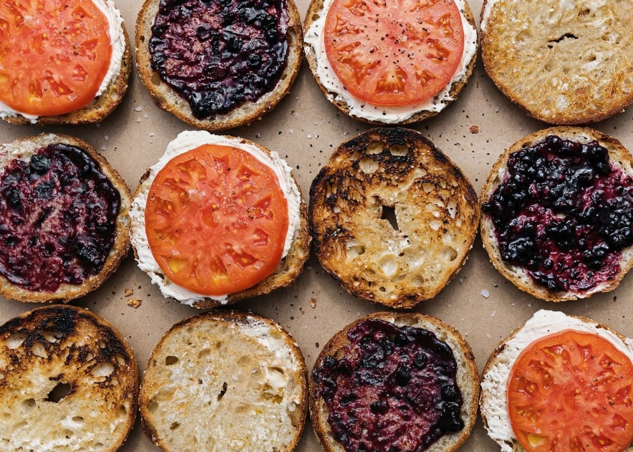 A selection of halved, toasted bagels, with various toppings