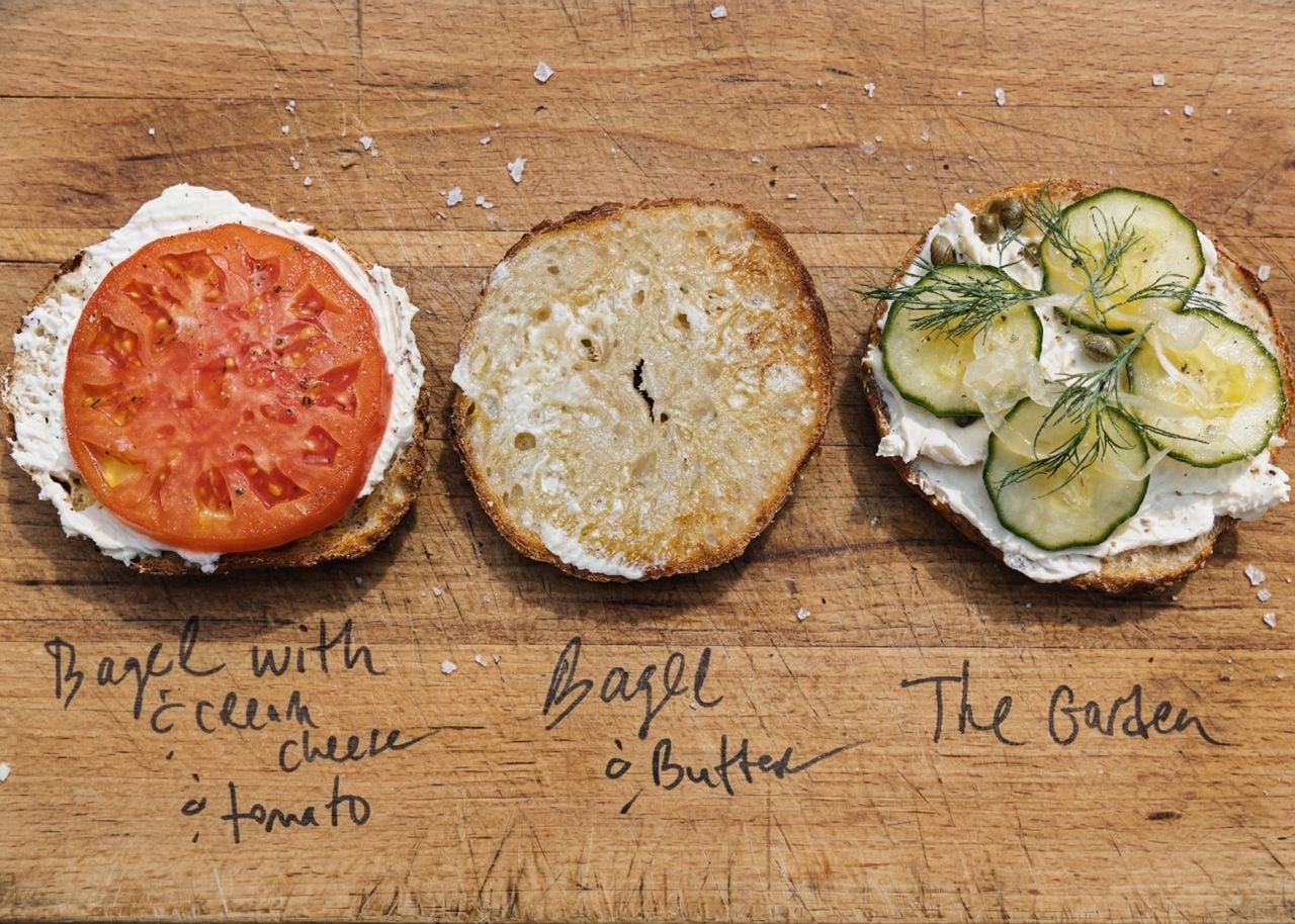Three bagel halves with various toppings