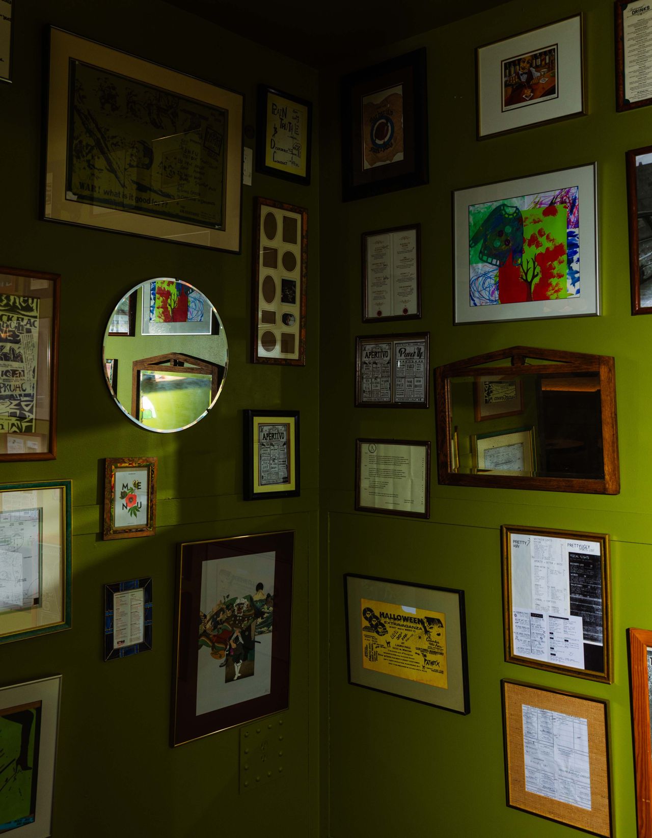 Framed mirrors and artwork hang on the wall at Dirty Laundry in Toronto