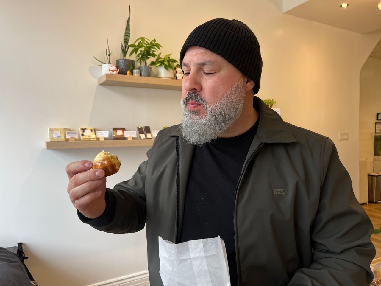 Chef Moeen Abuzaid takes a bite of a lemon madeleine