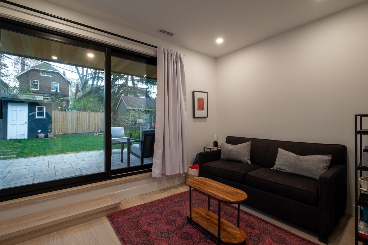 Inside a sloped two-storey Danforth garden suite with cathedral ceilings