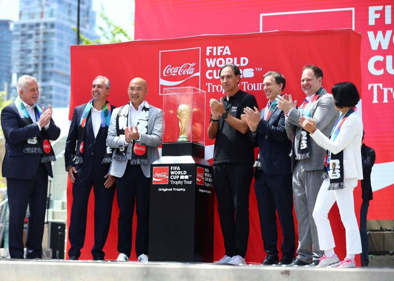 A lineup of FIFA and city officials unveiling the World Cup trophy