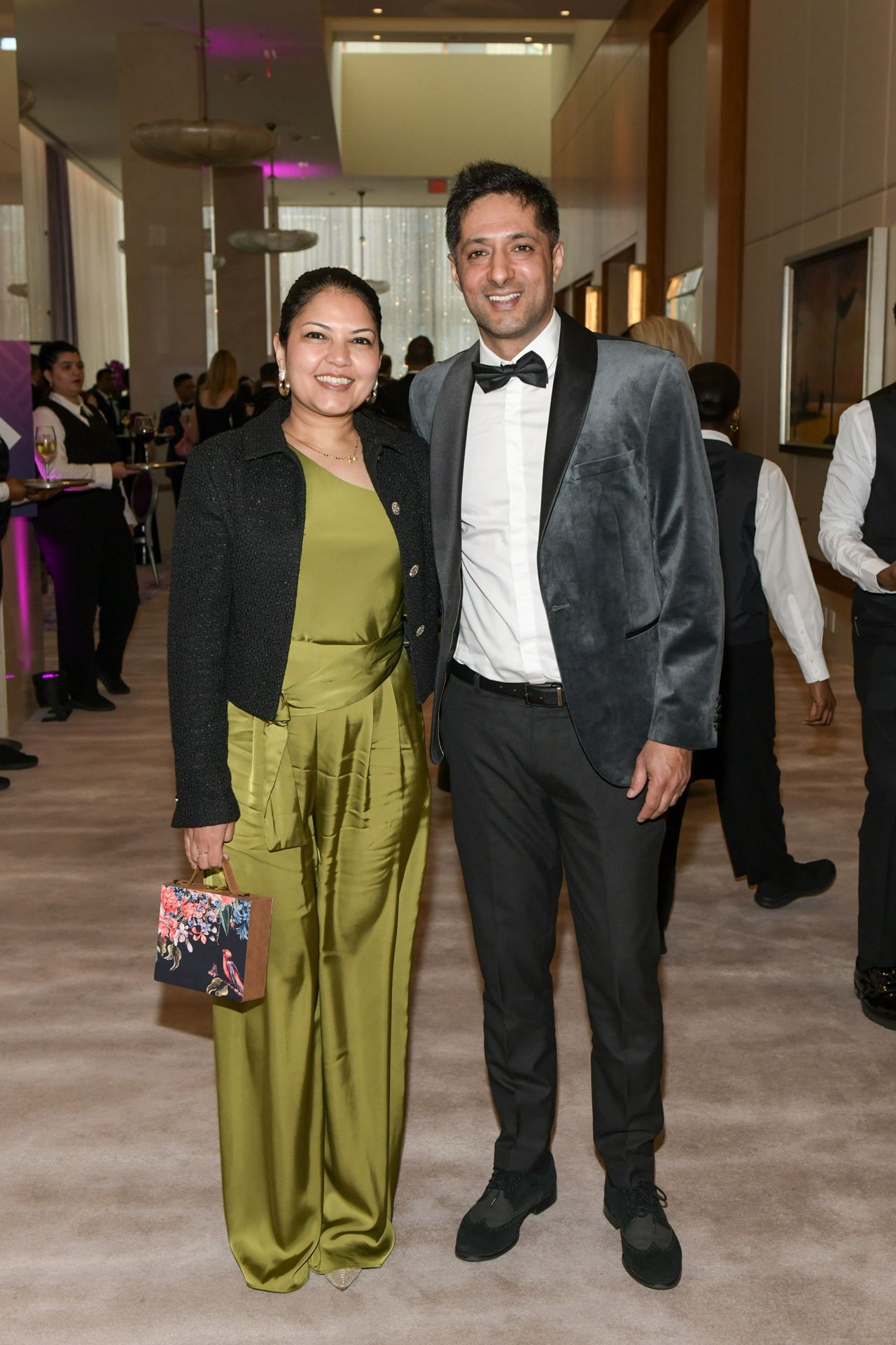 Woman in green dress and man in suede suit jacket