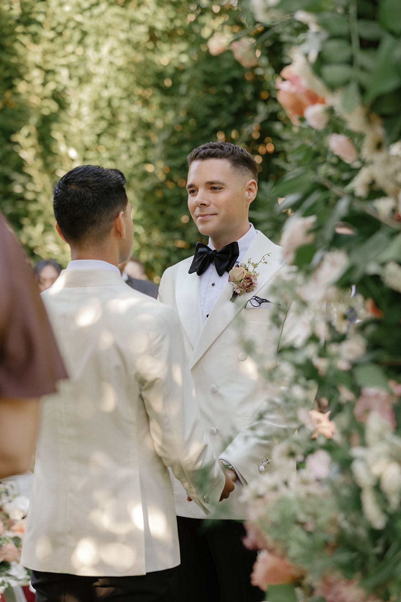 Close-up of grooms saying vows