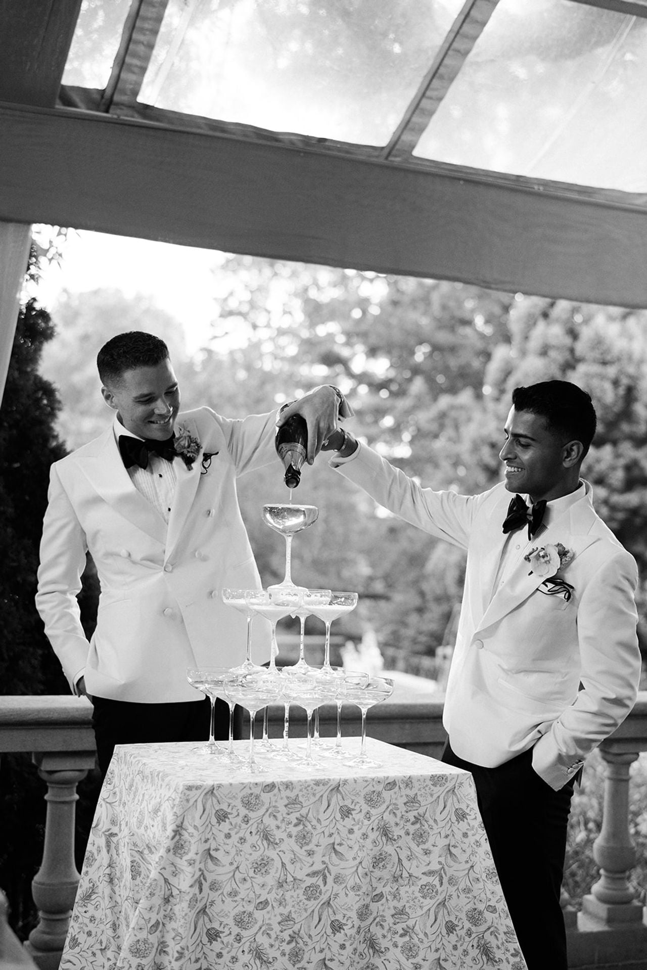 Two grooms pouring champagne