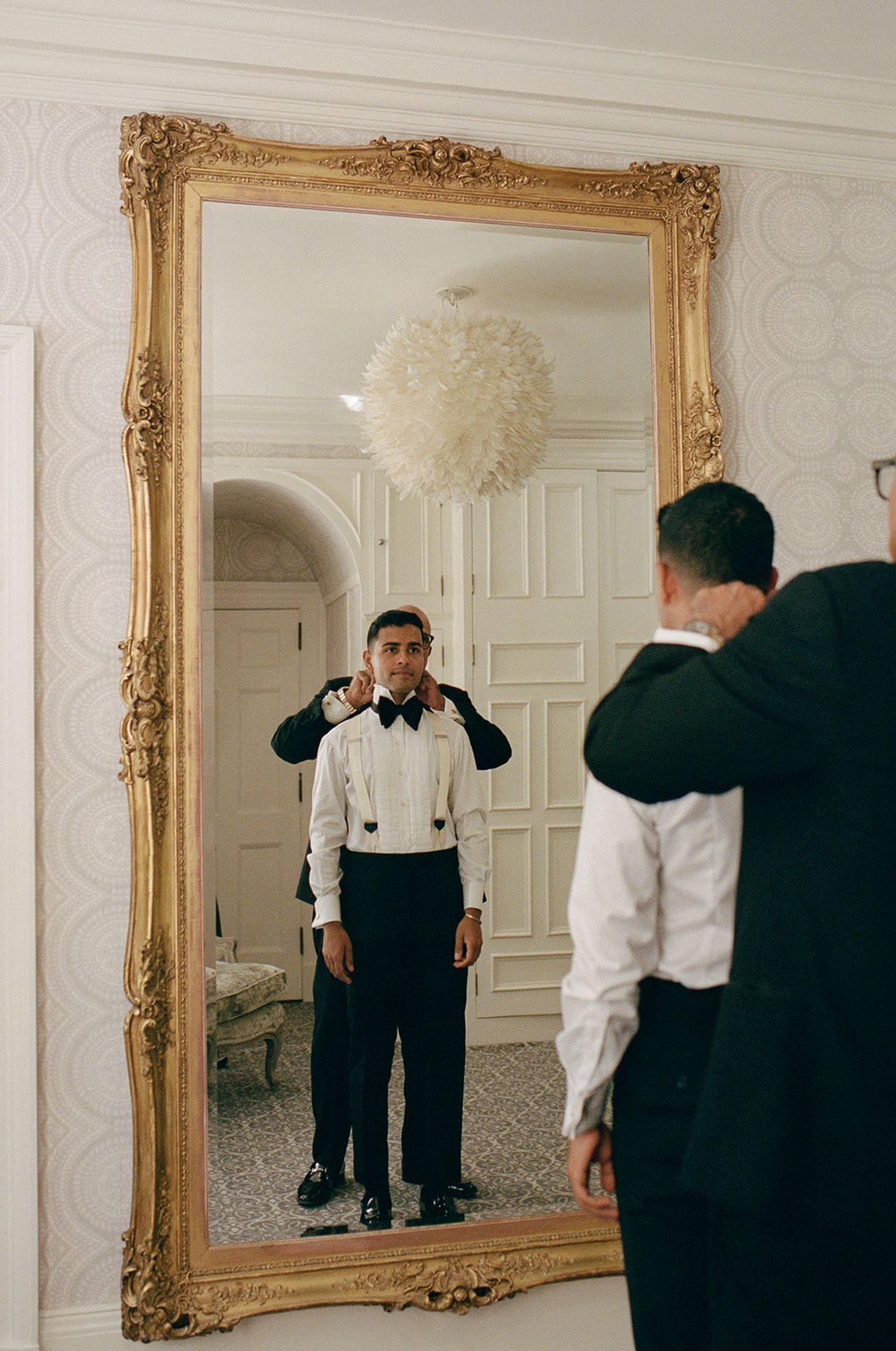 Man putting a suit jacket on