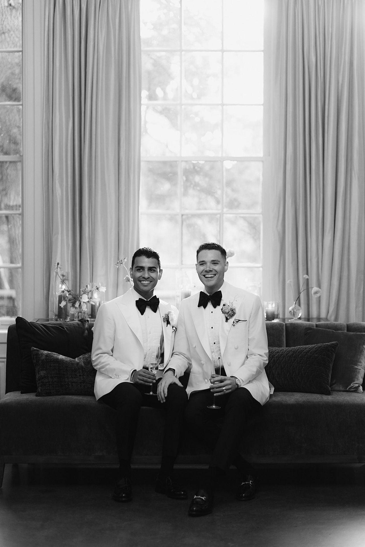 Two grooms sitting side-by-side