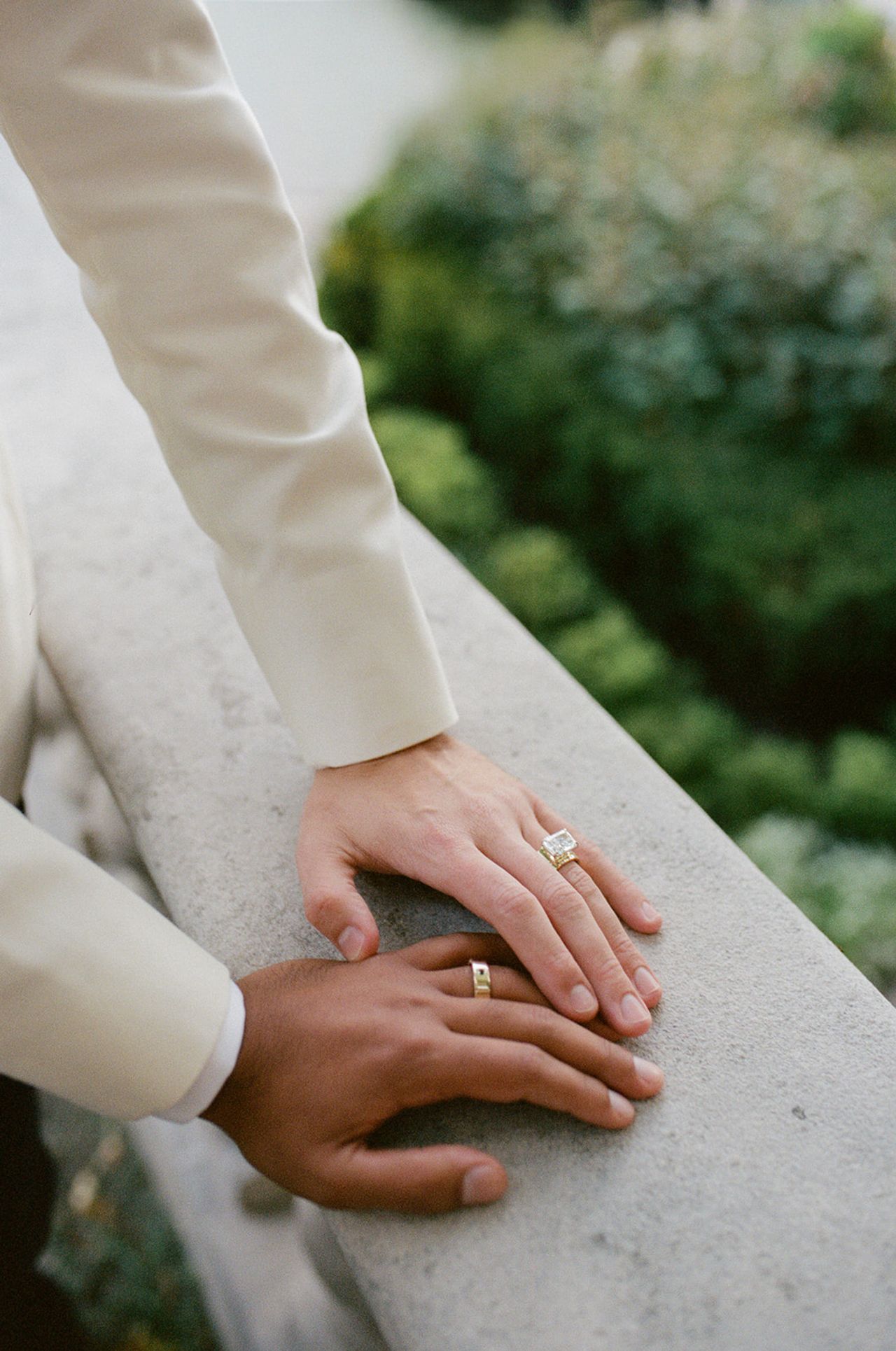 Close-up of two hands with wedding rings on