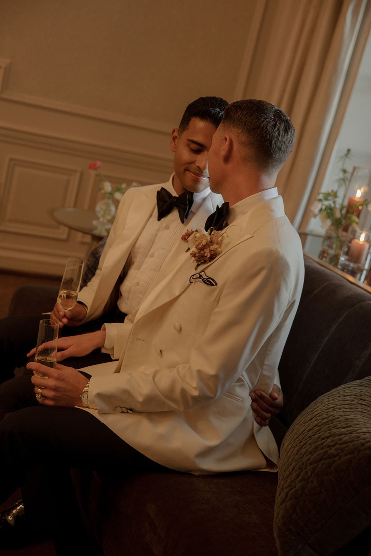 Two grooms embracing one another