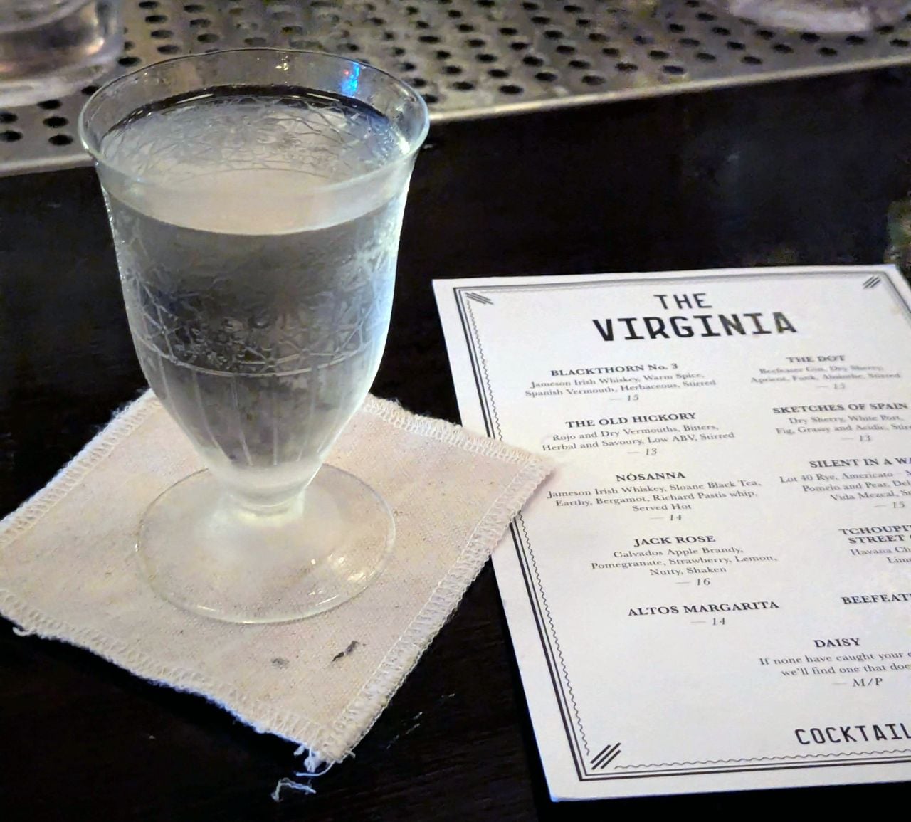 A martini-like cocktail and the menu at the Virginia